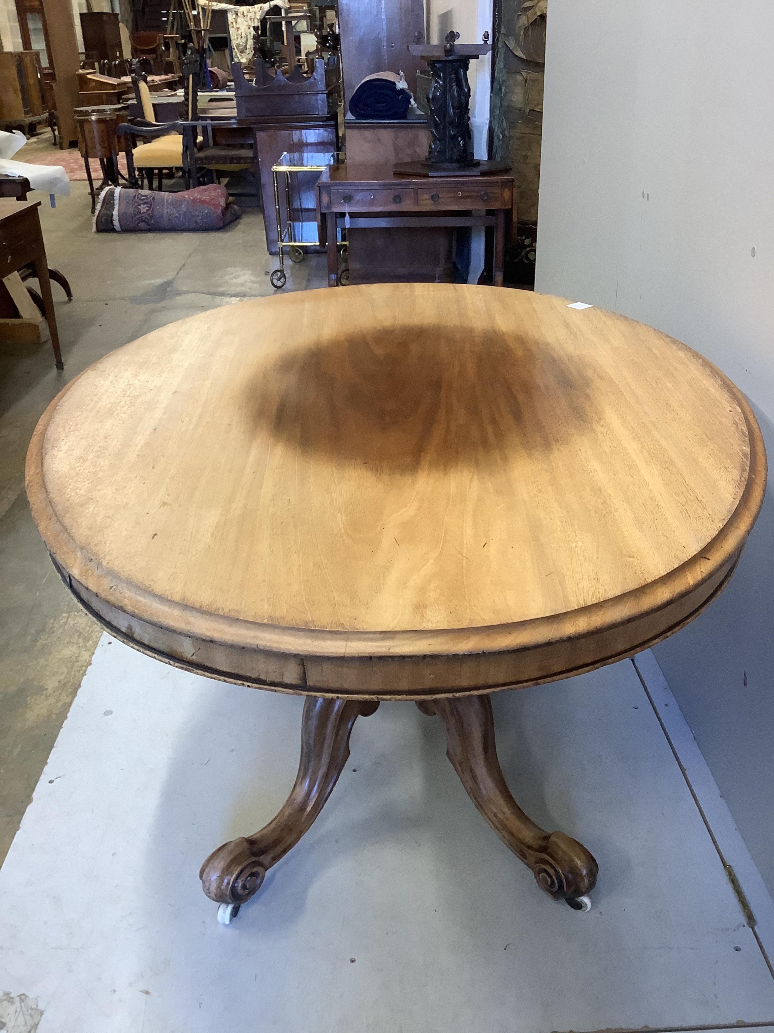 A Victorian faded mahogany oval tilt top loo table, width 137cm, depth 103cm, height 73cm